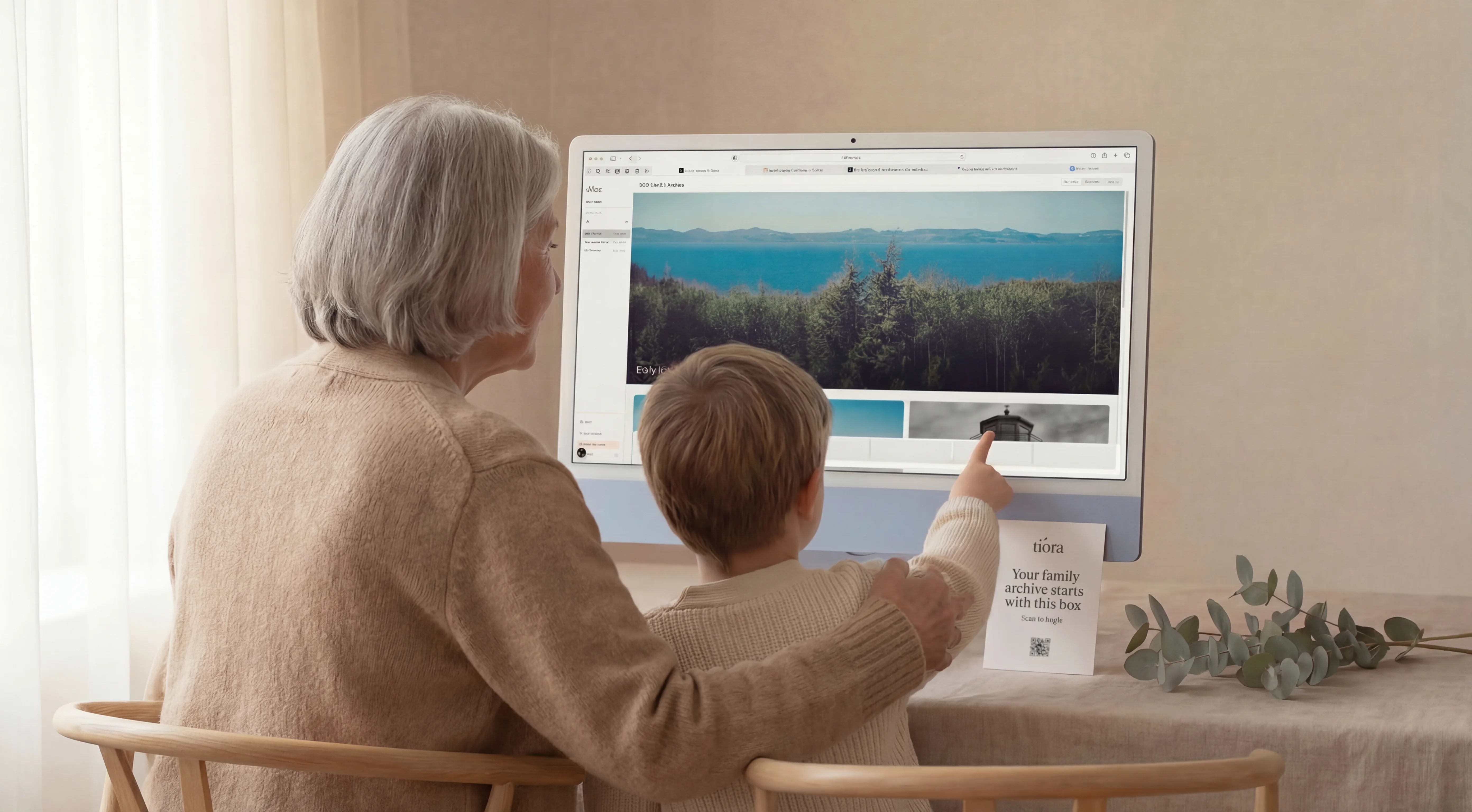 Grandmother and grandson viewing a family archive together on a desktop screen
