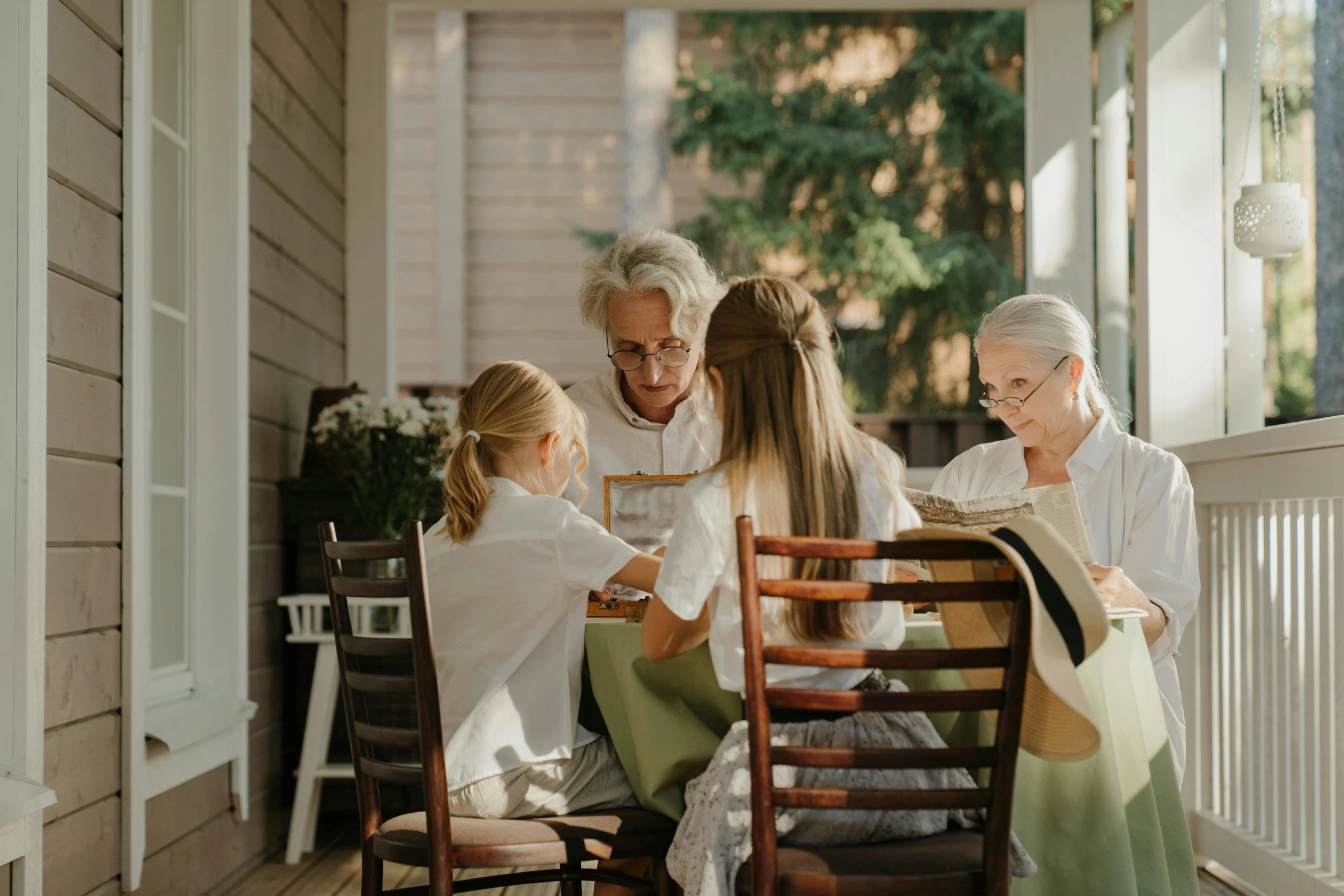 Grandparents and grandchildren looking through family photographs together