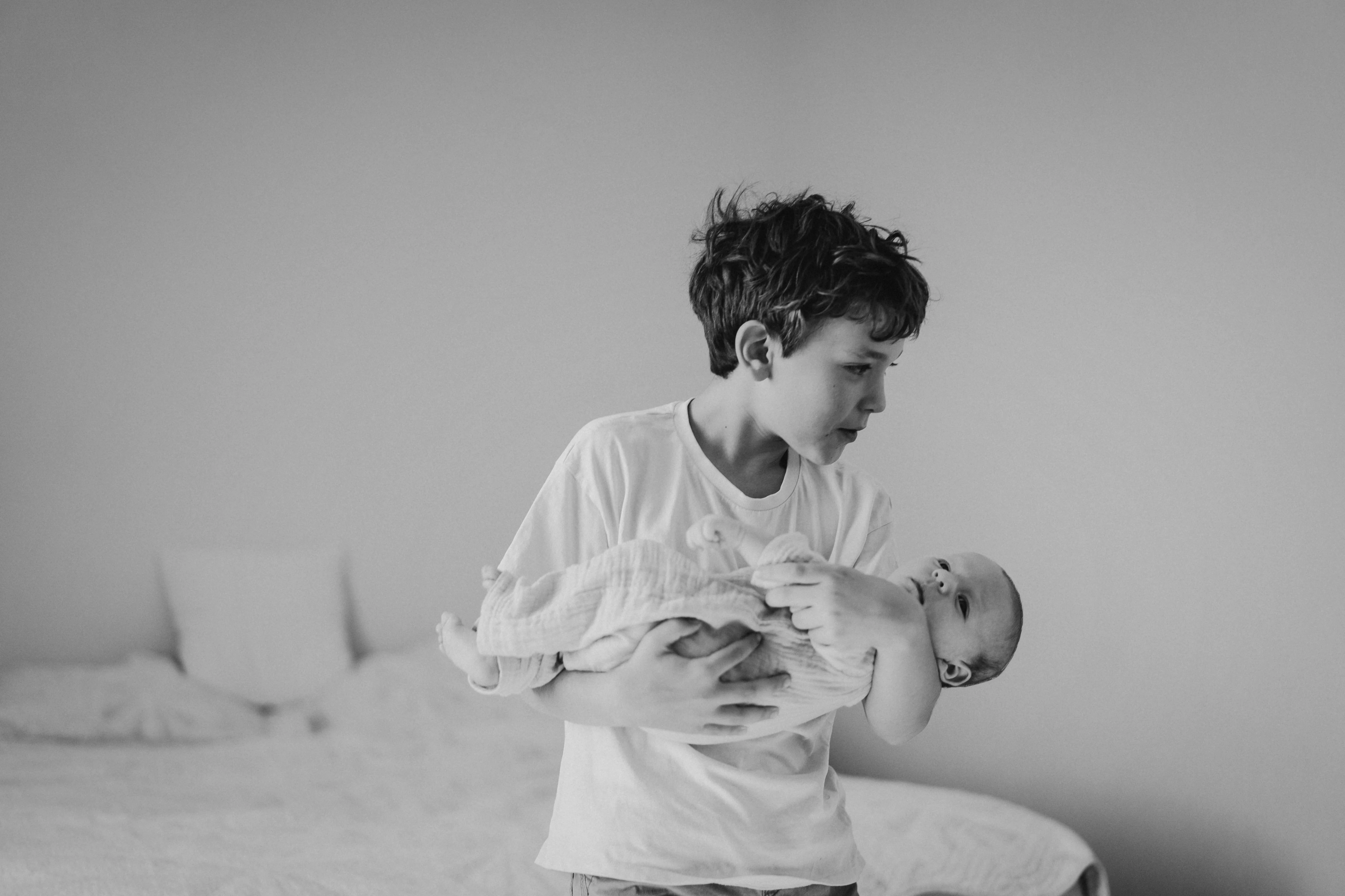 Older brother with newborn — family archive preservation